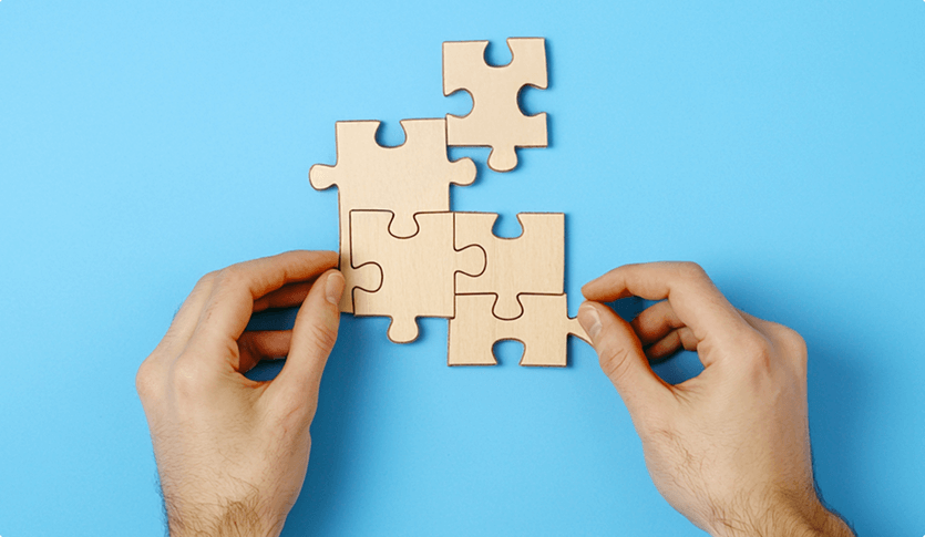 Image of hands doing puzzles